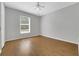 Empty bedroom with wood-look floors, a ceiling fan, and a window for natural light at 881 Westline Ave, Deltona, FL 32725