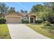 Charming home with a two-car garage, well-maintained lawn, and inviting front entrance with decorative columns at 881 Westline Ave, Deltona, FL 32725