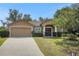 Charming home with a two-car garage, well-maintained lawn, and inviting front entrance with decorative columns at 881 Westline Ave, Deltona, FL 32725