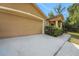 Spacious two-car garage with a concrete driveway and neatly landscaped walkway leading to the front entrance at 881 Westline Ave, Deltona, FL 32725
