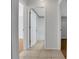 Hallway with tiled floors, neutral paint, and multiple doorways leading to various rooms at 881 Westline Ave, Deltona, FL 32725
