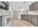 Open-concept kitchen and dining area with white appliances and breakfast bar at 881 Westline Ave, Deltona, FL 32725