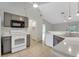 Bright kitchen showcasing modern appliances, gray cabinets, and open layout to the living area at 881 Westline Ave, Deltona, FL 32725