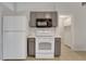 Kitchen featuring appliances and ample storage with painted cabinets and tile flooring at 881 Westline Ave, Deltona, FL 32725