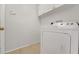 Functional laundry area featuring a washer and dryer with white cabinets at 881 Westline Ave, Deltona, FL 32725