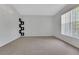 Empty living room featuring plush carpet, natural light and decorative elements at 881 Westline Ave, Deltona, FL 32725