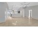 Bright and open living room with neutral paint, tile flooring, and a view into the kitchen area at 881 Westline Ave, Deltona, FL 32725