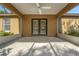 A covered patio with tile flooring and a ceiling fan, offering a cool outdoor space at 881 Westline Ave, Deltona, FL 32725