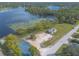 Aerial perspective of a charming lakeside property near a playground, with inviting picnic spots at 991 Dawson Dr, Deltona, FL 32725