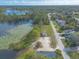 Aerial view of a serene property near a lake, showcasing natural beauty and community amenities at 991 Dawson Dr, Deltona, FL 32725