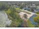 Drone shot reveals a tranquil lakeside property with playground and picnic area, perfect for outdoor enjoyment at 991 Dawson Dr, Deltona, FL 32725