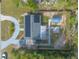 Aerial view of home with solar panels, shed, and paved driveway at 991 Dawson Dr, Deltona, FL 32725