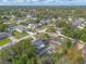 An aerial view shows a neighborhood with well-maintained lawns and mature trees in a beautiful sunny location at 991 Dawson Dr, Deltona, FL 32725