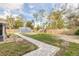 Fenced backyard with large storage shed, pavers, and tropical landscaping at 991 Dawson Dr, Deltona, FL 32725