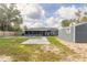 Spacious backyard featuring a shed, green grass, and concrete pavers at 991 Dawson Dr, Deltona, FL 32725
