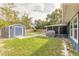 Well-maintained backyard with a large shed and a screened-in porch at 991 Dawson Dr, Deltona, FL 32725