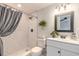 Bathroom features subway tile surround in the shower, white vanity, and updated fixtures at 991 Dawson Dr, Deltona, FL 32725