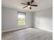 Bedroom features tile flooring, natural light, and a ceiling fan at 991 Dawson Dr, Deltona, FL 32725