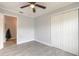 Neutral bedroom with wood-look tile floors and a lighted ceiling fan at 991 Dawson Dr, Deltona, FL 32725