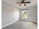 Bedroom features tile flooring, natural light, and a closet at 991 Dawson Dr, Deltona, FL 32725