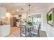 Eat-in kitchen with modern stainless steel appliances, tiled backsplash, and a glass dining table at 991 Dawson Dr, Deltona, FL 32725