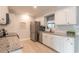 Bright kitchen featuring granite countertops, stainless steel appliances, and ample cabinet space at 991 Dawson Dr, Deltona, FL 32725