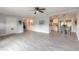 Spacious living area with tile floors seamlessly connected to a dining area and kitchen at 991 Dawson Dr, Deltona, FL 32725