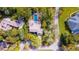 Aerial view of house and pool outlined in red, surrounded by mature trees at 1 Crooked Bridge Way, Ormond Beach, FL 32174