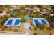 Aerial view of tennis and basketball courts surrounded by lush greenery at 1 Crooked Bridge Way, Ormond Beach, FL 32174