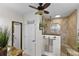 Well-designed bathroom featuring a glass shower, granite countertop, and stylish fixtures with a ceiling fan at 1 Crooked Bridge Way, Ormond Beach, FL 32174