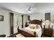 Cozy bedroom featuring a wood-framed bed, bedside tables with lamps, and window with natural light at 1 Crooked Bridge Way, Ormond Beach, FL 32174