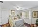 Cozy bedroom features a mirrored dresser, window with blinds, and an ornate metal bed frame at 1 Crooked Bridge Way, Ormond Beach, FL 32174