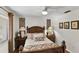 Comfortable bedroom featuring a ceiling fan, two side tables with lamps, and decorative wall art at 1 Crooked Bridge Way, Ormond Beach, FL 32174