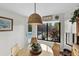 Bright breakfast nook with wood table and view of outdoor pool area at 1 Crooked Bridge Way, Ormond Beach, FL 32174