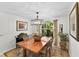 Dining room with a wood table, neutral walls, chandelier, rug and window with lots of natural light at 1 Crooked Bridge Way, Ormond Beach, FL 32174