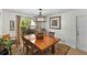 Dining room with a wood table, neutral walls, chandelier, rug and window with lots of natural light at 1 Crooked Bridge Way, Ormond Beach, FL 32174