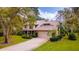 Charming two-story home with a well-maintained lawn and mature trees at 1 Crooked Bridge Way, Ormond Beach, FL 32174