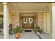 Welcoming front entrance features double doors, brick accents, seasonal decor, and a cozy sitting area at 1 Crooked Bridge Way, Ormond Beach, FL 32174
