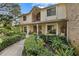 Inviting two-story home featuring a covered front porch, manicured landscaping, and a brick facade at 1 Crooked Bridge Way, Ormond Beach, FL 32174