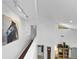 Bright upper hallway with modern lighting, a large painting, and views down to the spacious living area at 1 Crooked Bridge Way, Ormond Beach, FL 32174