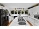Bright kitchen features white cabinetry, marble countertops, and stainless-steel appliances at 1 Crooked Bridge Way, Ormond Beach, FL 32174