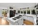 Open kitchen with large center island, white cabinets, and modern appliances at 1 Crooked Bridge Way, Ormond Beach, FL 32174