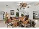Bright living room with high ceilings, fan, staircase, neutral walls and tile flooring, as well as a large leather couch at 1 Crooked Bridge Way, Ormond Beach, FL 32174