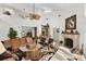 Bright living room with high ceilings, neutral walls and tile flooring, with fireplace and large leather couch at 1 Crooked Bridge Way, Ormond Beach, FL 32174