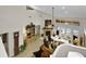 Open living room with high ceilings, a fireplace, tile floors, and views of the pool through glass doors at 1 Crooked Bridge Way, Ormond Beach, FL 32174