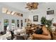 Bright living room with high ceilings, ceiling fan, and views of the pool outside at 1 Crooked Bridge Way, Ormond Beach, FL 32174