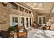 Spacious patio with brick walls, ceiling fans and access to the outdoor pool at 1 Crooked Bridge Way, Ormond Beach, FL 32174