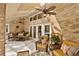 Covered patio with brick walls, comfortable seating, ceiling fans, and access to the backyard at 1 Crooked Bridge Way, Ormond Beach, FL 32174