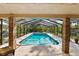 Inviting screened-in pool features clear blue water, ample sunlight, and outdoor greenery at 1 Crooked Bridge Way, Ormond Beach, FL 32174
