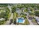 Community featuring a pool, tennis court, and tree-lined streets at 1502 Deer Springs Rd, Port Orange, FL 32129